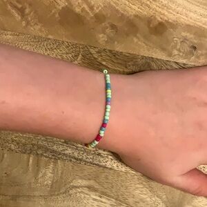 It is a kids bracelet multicolored about 5 inches long